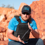 Man Holding Front Plate for Body Armor Kit